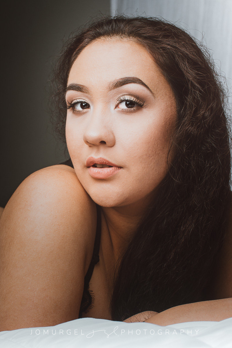 woman on bed looking away from camera