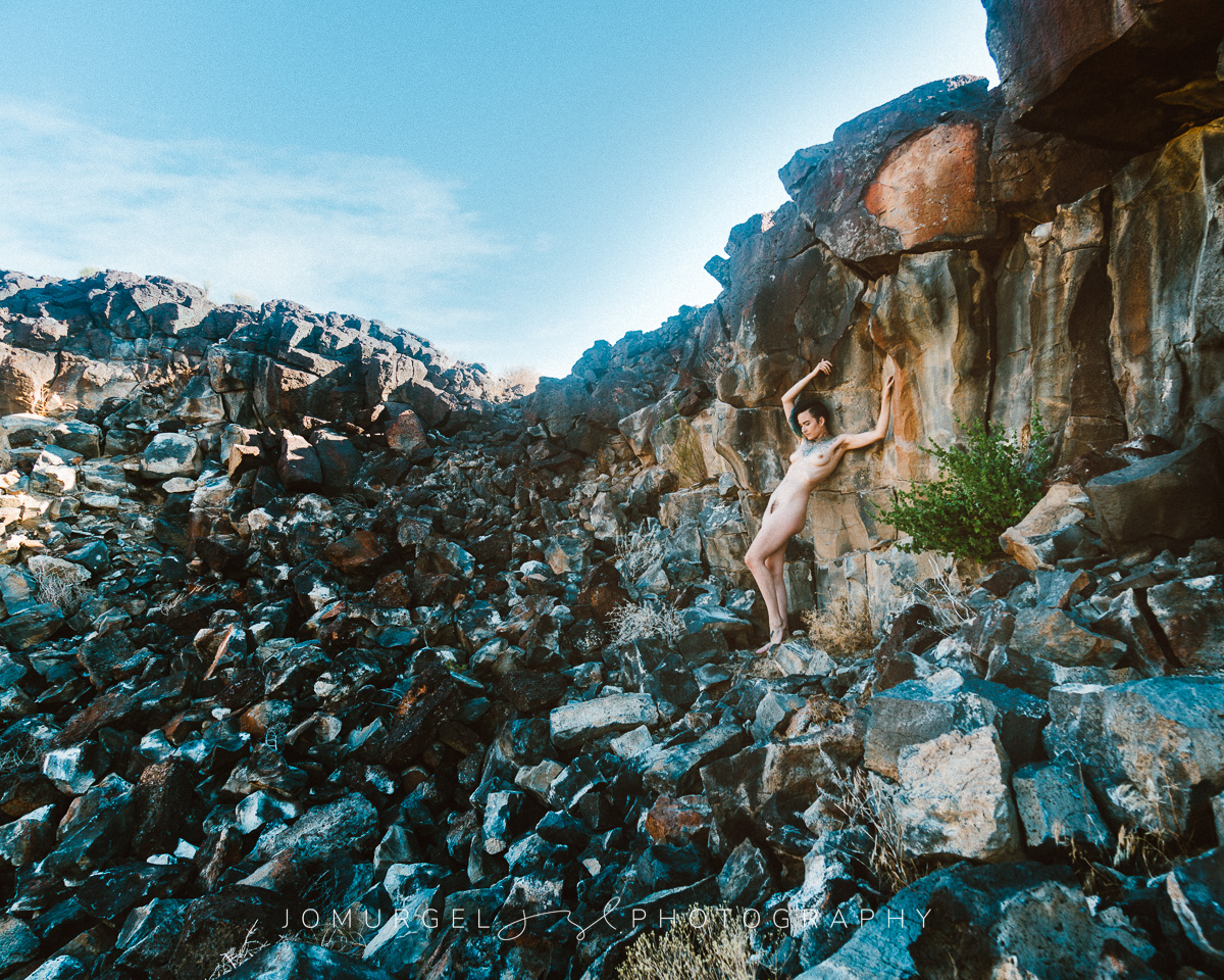 nude woman posed on rocks in color